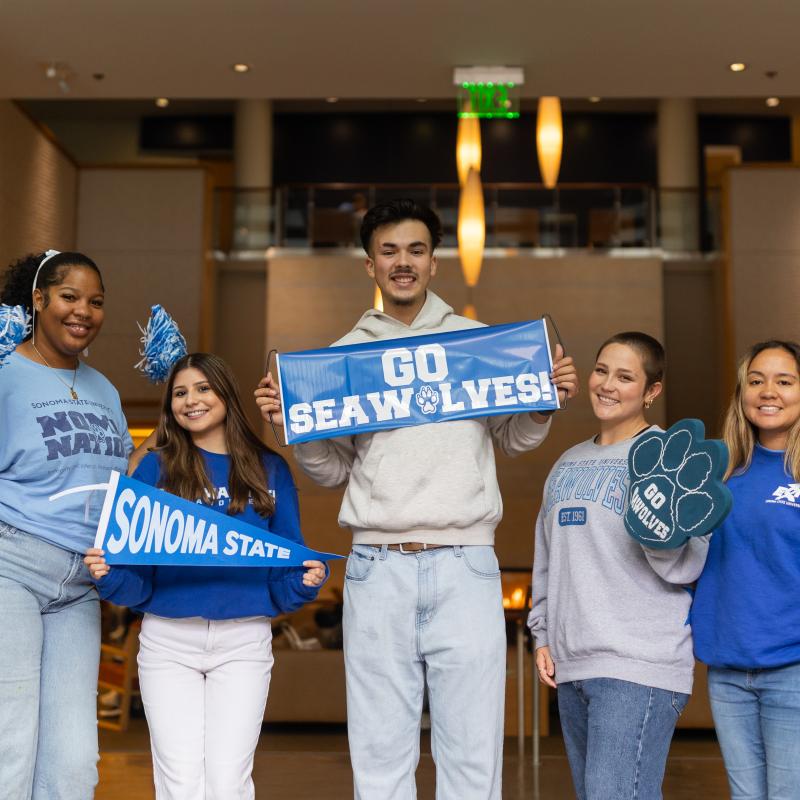 Students holding SSU pennants at the Student Center
